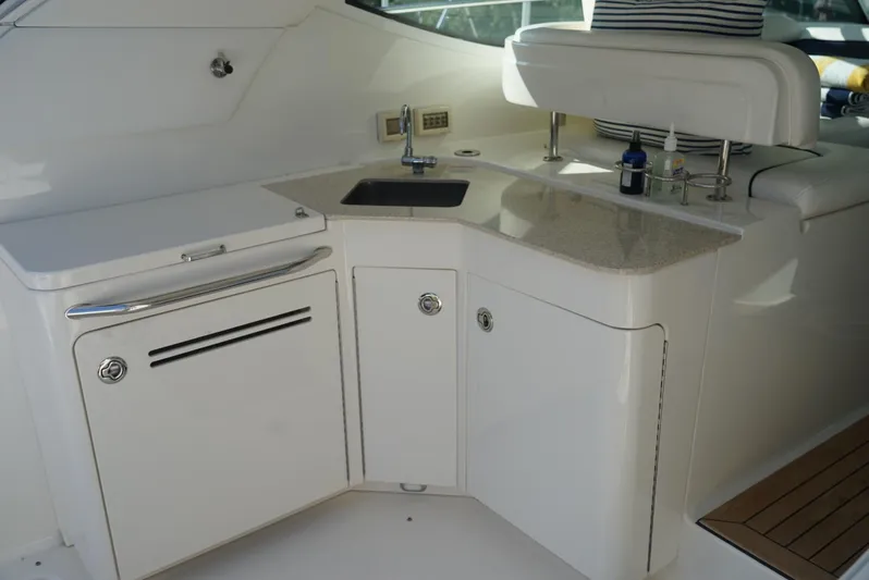 L' Aventura Yacht Photos Pics 2010 Sea Ray 470 Sundancer yacht kitchenette with sink and storage cabinets.