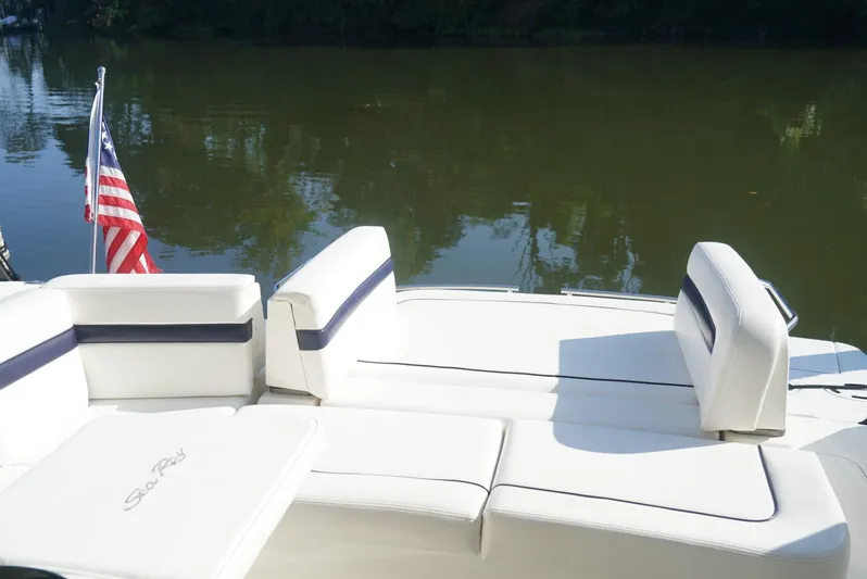 L' Aventura Yacht Photos Pics 2010 Sea Ray 470 Sundancer boat with American flag, white seating, and calm water backdrop.