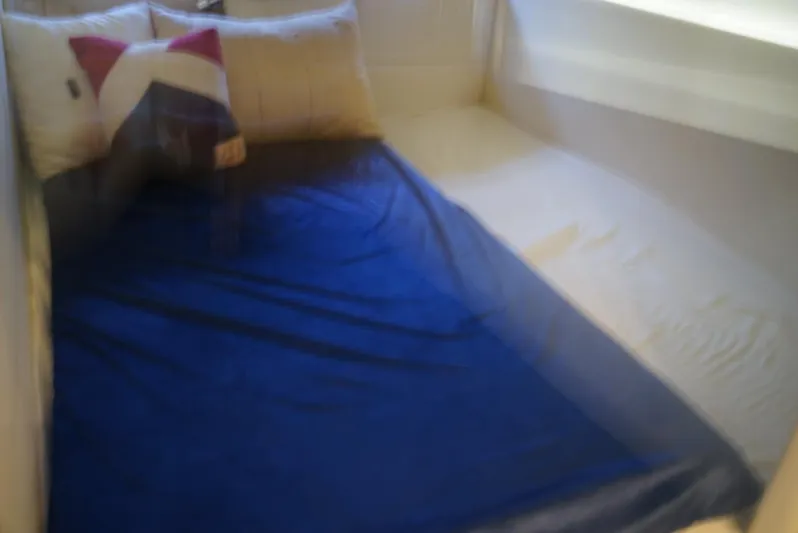 L' Aventura Yacht Photos Pics Cozy cabin bed with blue blanket in 2010 Sea Ray 470 Sundancer yacht.