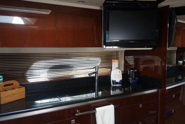 L' Aventura Yacht Photos Pics Luxurious kitchen interior of 2010 Sea Ray 470 Sundancer yacht with modern amenities.