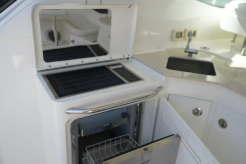 L' Aventura Yacht Photos Pics 2010 Sea Ray 470 Sundancer yacht interior with open fridge and sink.