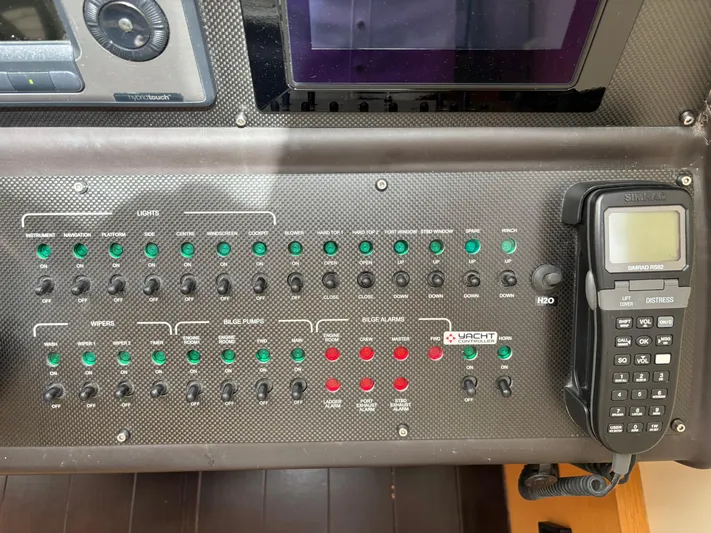  Yacht Photos Pics Control panel of a 2011 Pershing 64 yacht with switches and a Simrad RS82 radio.