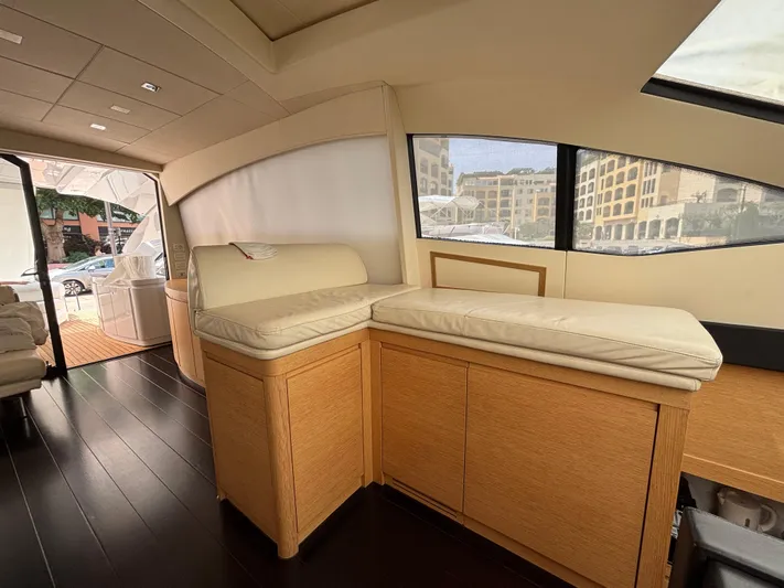  Yacht Photos Pics Interior of 2011 Pershing 64 yacht with beige seating and wooden cabinetry.