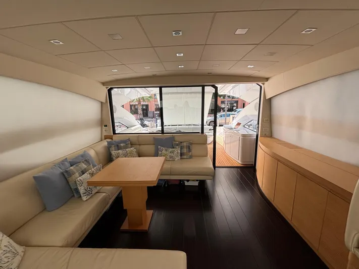  Yacht Photos Pics Luxurious interior of a 2011 Pershing 64 yacht with elegant seating and wooden accents.