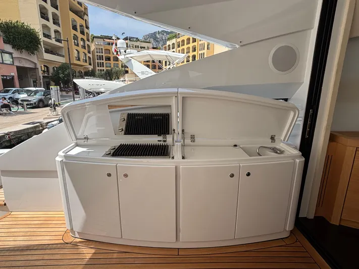  Yacht Photos Pics Outdoor kitchen on a 2011 Pershing 64 yacht, featuring a grill and sink.