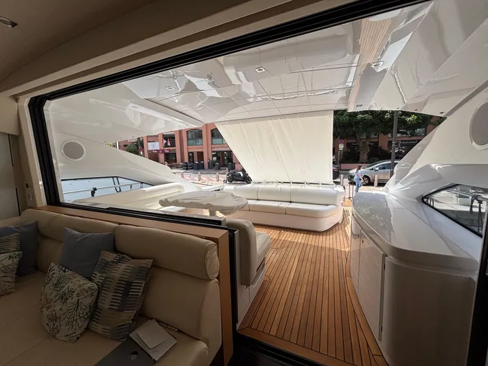  Yacht Photos Pics Luxurious interior of a 2011 Pershing 64 yacht with elegant seating and wooden deck.