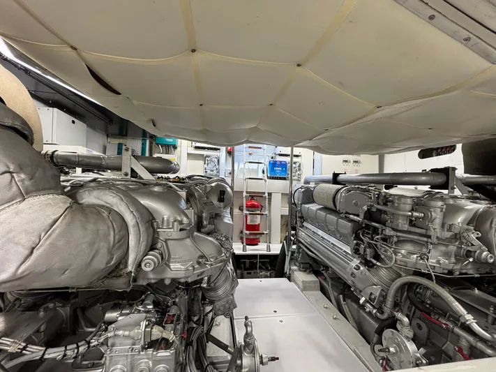  Yacht Photos Pics Engine room of a 2011 Pershing 64 yacht, showcasing dual engines and mechanical components.