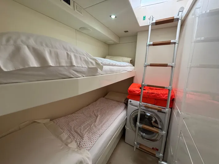  Yacht Photos Pics Compact cabin with bunk beds, ladder, and washing machine on a 2011 Pershing 64 yacht.