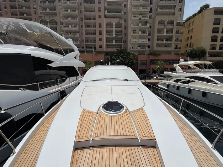  Yacht Photos Pics 2011 Pershing 64 yacht docked in marina, surrounded by luxury boats and waterfront buildings.