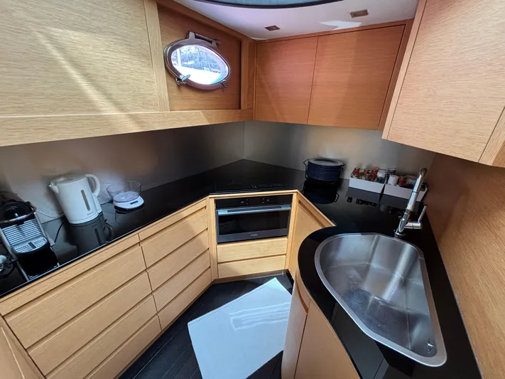  Yacht Photos Pics Luxurious kitchen interior of 2011 Pershing 64 yacht with modern appliances and sleek design.