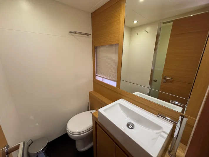  Yacht Photos Pics Modern bathroom in 2011 Pershing 64 yacht with sleek sink, toilet, and wood accents.