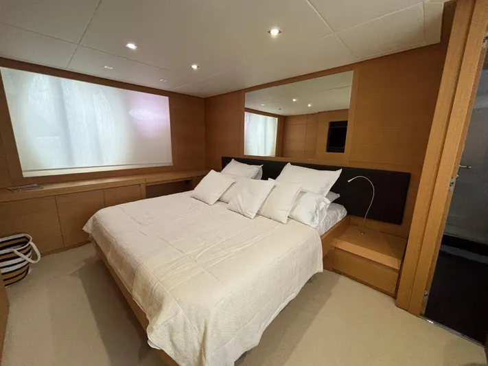  Yacht Photos Pics Luxurious bedroom interior on a 2011 Pershing 64 yacht, featuring a cozy bed and modern design.