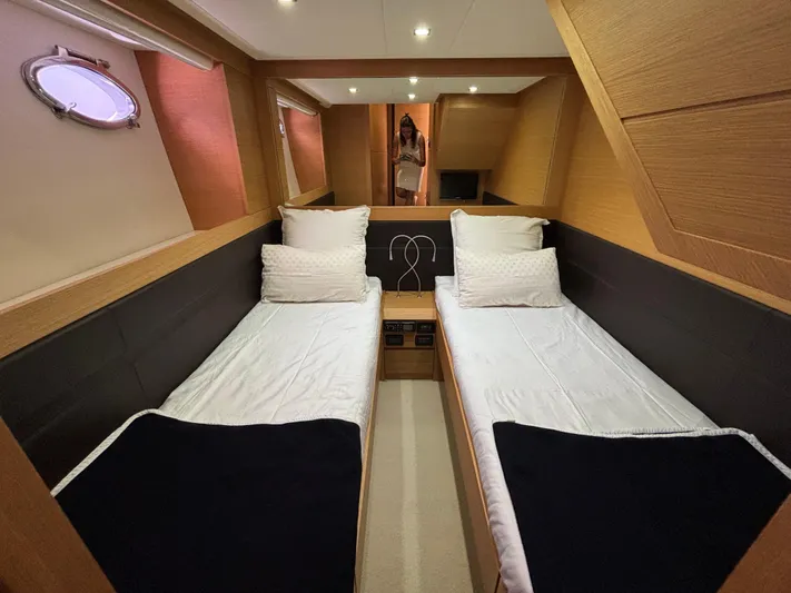  Yacht Photos Pics Luxurious twin cabin interior of 2011 Pershing 64 yacht with modern wood finish.