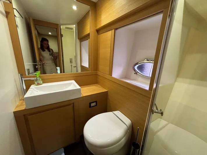  Yacht Photos Pics Luxurious bathroom interior of 2011 Pershing 64 yacht with modern fixtures and wooden accents.