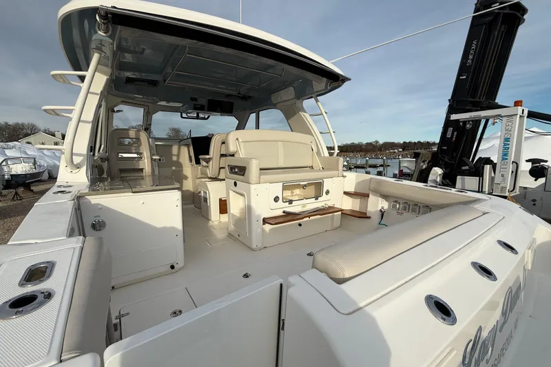 Siper Brokerage Yacht Photos Pics 2021 Boston Whaler 380 Realm boat interior with seating and helm, docked at marina.