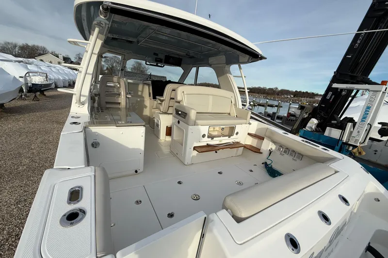 Siper Brokerage Yacht Photos Pics 2021 Boston Whaler 380 Realm boat interior with seating and storage, docked at marina.