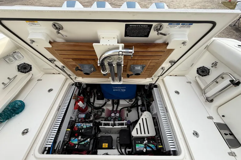 Siper Brokerage Yacht Photos Pics 2021 Boston Whaler 380 Realm engine compartment with open hatch, showcasing detailed components.