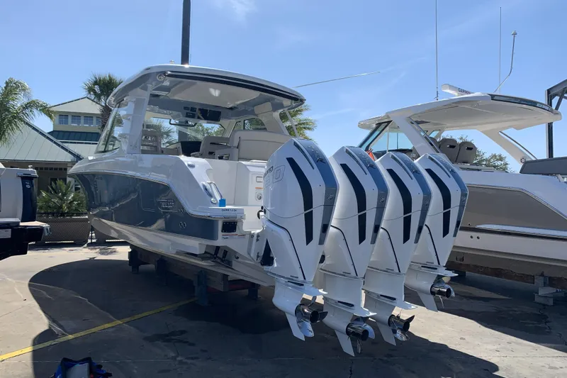 Siper Brokerage Yacht Photos Pics 2021 Boston Whaler 380 Realm with four powerful outboard engines, docked under clear skies.