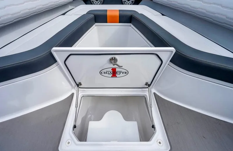  Yacht Photos Pics 2023 Cigarette 41 Nighthawk boat storage compartment with open lid, showcasing sleek interior design.