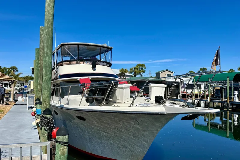 Anchored Souls Yacht Photos Pics 1988 Californian 45 Motor Yacht docked at marina under clear blue sky.