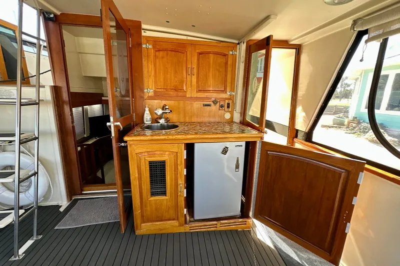 Anchored Souls Yacht Photos Pics 1988 Californian 45 Motor Yacht interior with wooden cabinetry and compact kitchenette.