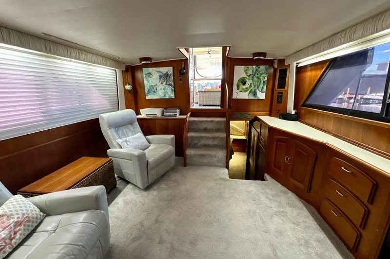Anchored Souls Yacht Photos Pics Interior of 1988 Californian 45 Motor Yacht with plush seating and wooden cabinetry.