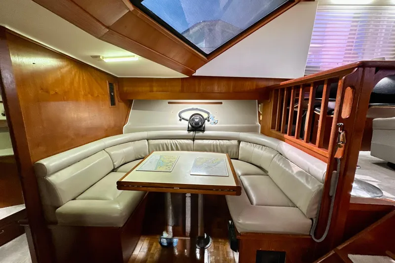 Anchored Souls Yacht Photos Pics 1988 Californian 45 Motor Yacht interior with cozy seating and wooden accents.