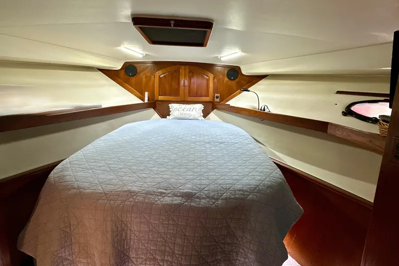 Anchored Souls Yacht Photos Pics Cozy cabin interior of 1988 Californian 45 Motor Yacht with bed and wooden accents.