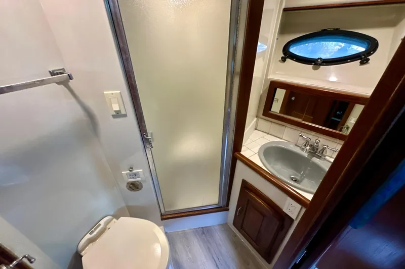 Anchored Souls Yacht Photos Pics 1988 Californian 45 Motor Yacht bathroom with shower, sink, and porthole window.