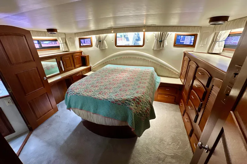 Anchored Souls Yacht Photos Pics 1988 Californian 45 Motor Yacht bedroom with wood furnishings and cozy decor.