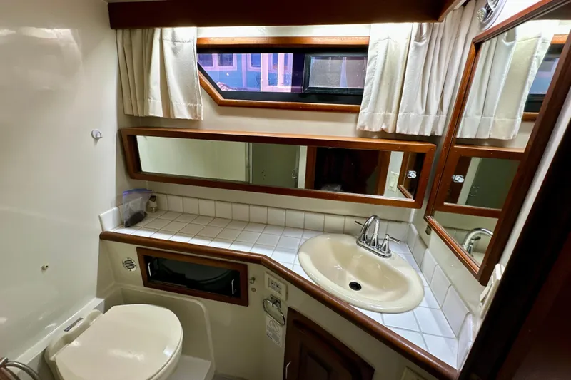 Anchored Souls Yacht Photos Pics Bathroom interior of 1988 Californian 45 Motor Yacht with sink, toilet, and mirror.
