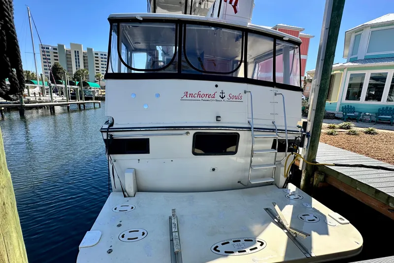 Anchored Souls Yacht Photos Pics 1988 Californian 45 Motor Yacht docked, rear view with "Anchored Souls" text.