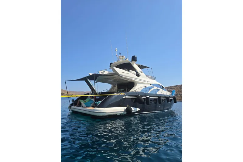 11:11 Yacht Photos Pics 2006 Azimut Fly 50 yacht on calm water under clear blue sky.