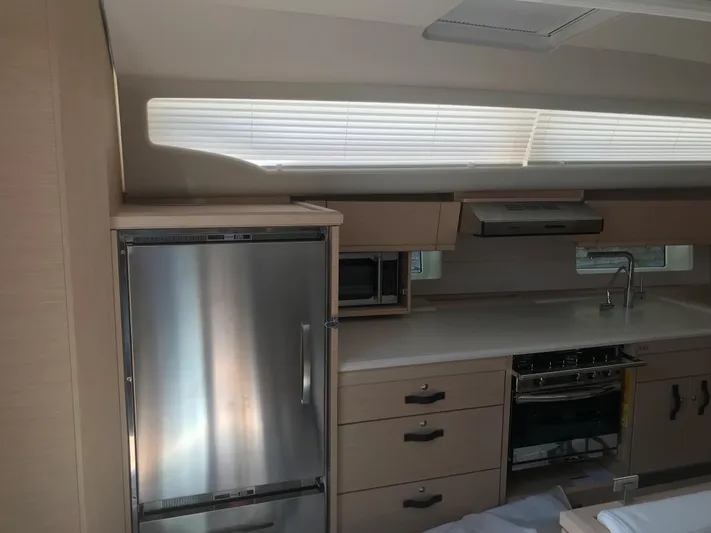  Yacht Photos Pics Modern kitchen interior of 2020 Jeanneau 54 yacht with stainless steel appliances.