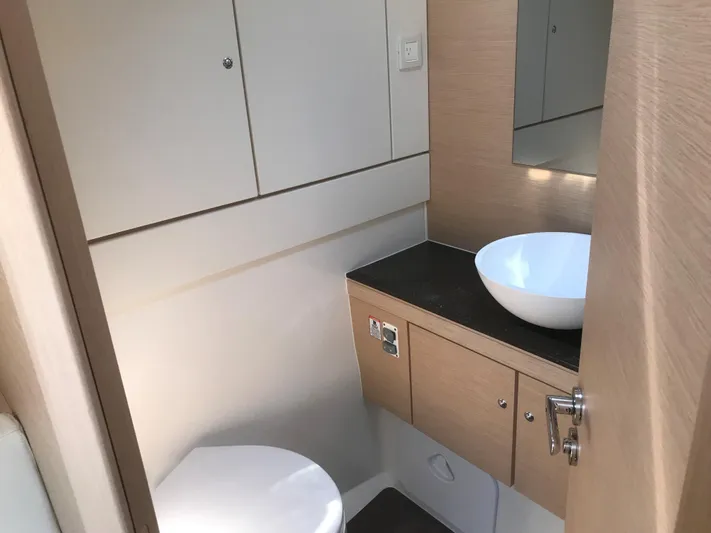  Yacht Photos Pics Modern bathroom interior on a 2020 Jeanneau 54 yacht, featuring sleek cabinetry and a vessel sink.