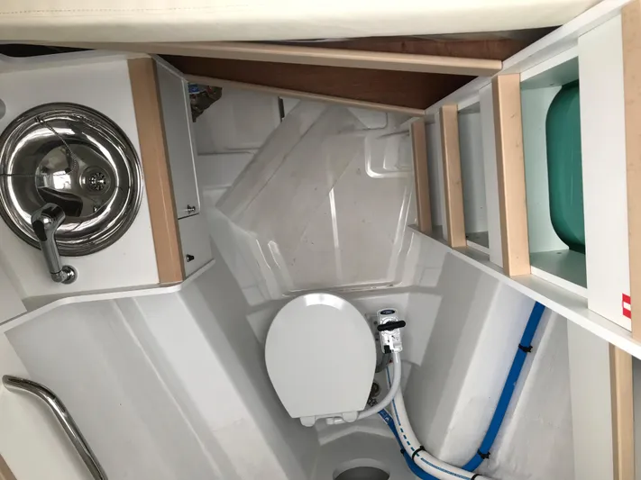  Yacht Photos Pics 2020 Jeanneau 54 yacht bathroom with sink, toilet, and storage shelves.