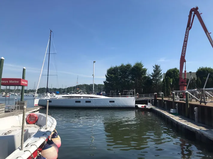  Yacht Photos Pics 2020 Jeanneau 54 yacht docked at marina under clear blue sky.