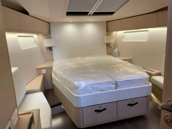  Yacht Photos Pics Luxurious cabin interior of 2020 Jeanneau 54 yacht with modern design and cozy bed.