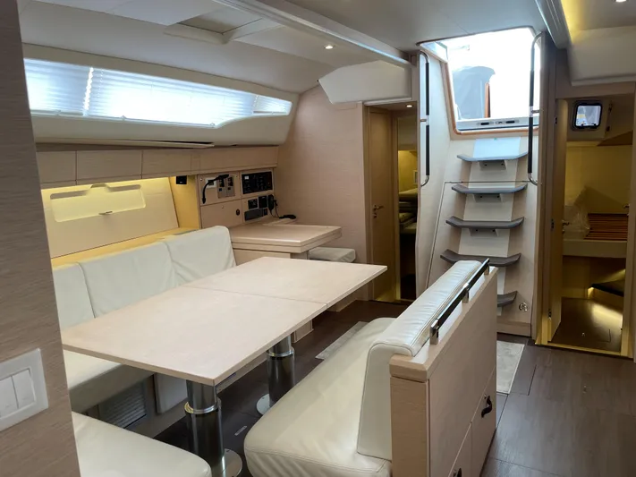  Yacht Photos Pics Interior of 2020 Jeanneau 54 yacht with modern dining area and staircase.