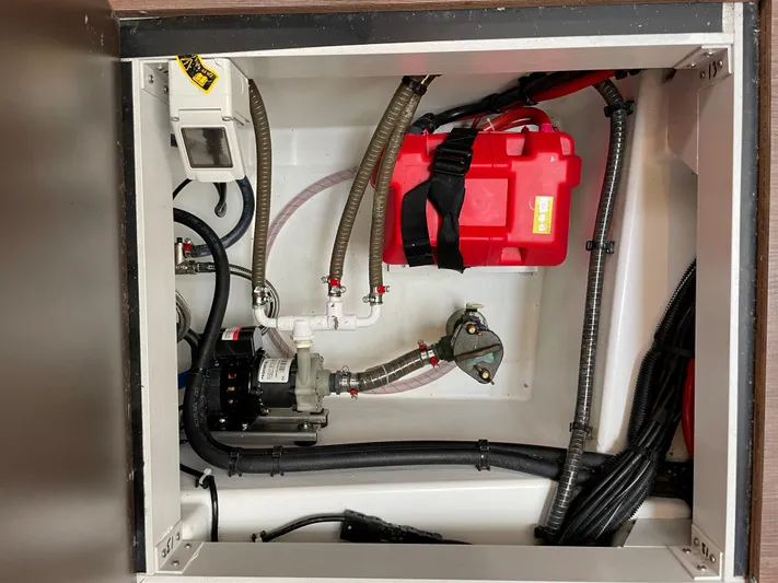  Yacht Photos Pics Engine compartment of a 2020 Jeanneau 54 yacht, featuring a red battery and various cables.