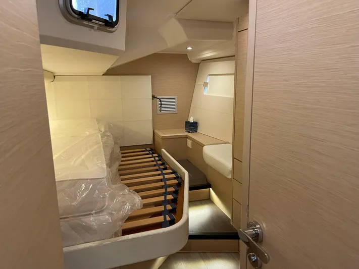  Yacht Photos Pics Interior cabin of 2020 Jeanneau 54 yacht, featuring modern design and cozy sleeping area.