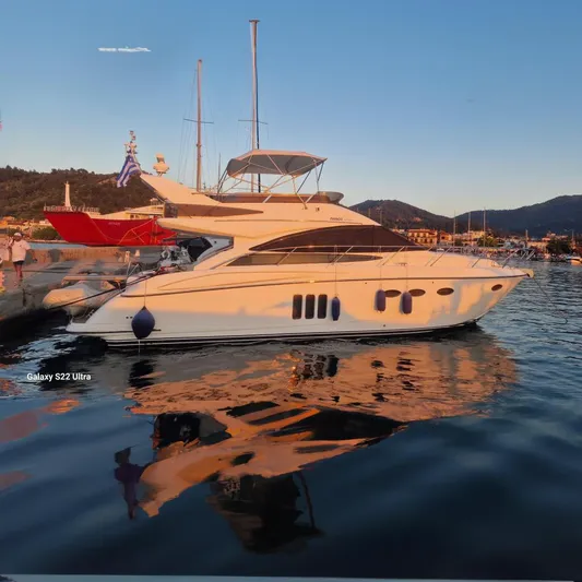  Yacht Photos Pics 2008 Princess 50 yacht docked at sunset, reflecting on calm water.