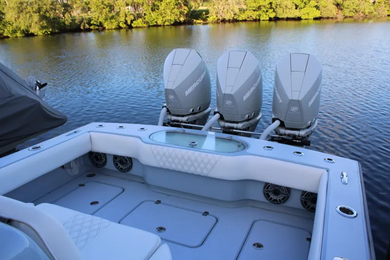  Yacht Photos Pics 2019 Conch 33 boat with triple Mercury engines on a calm river.