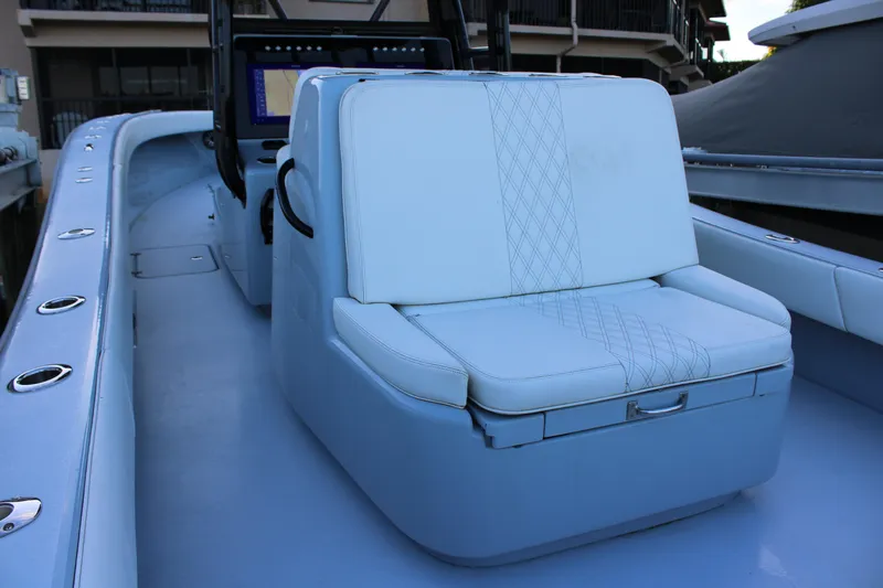  Yacht Photos Pics 2019 Conch 33 boat interior with cushioned seating and control panel.