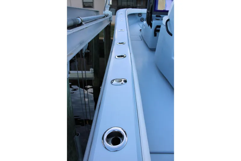  Yacht Photos Pics 2019 Conch 33 boat deck with rod holders, docked by the water.