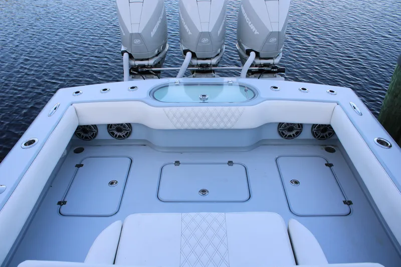  Yacht Photos Pics 2019 Conch 33 boat interior with triple Mercury engines, spacious seating, and storage compartments.