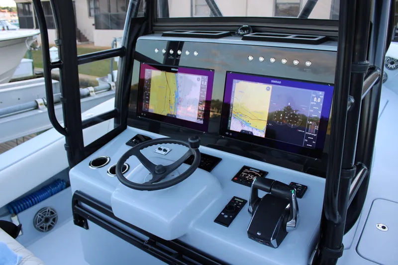  Yacht Photos Pics 2019 Conch 33 boat dashboard with dual Simrad navigation screens and steering wheel.