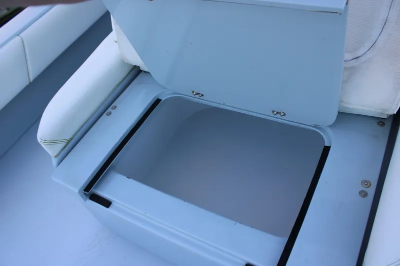  Yacht Photos Pics Open storage compartment on a 2019 Conch 33 boat, featuring blue and white seating.