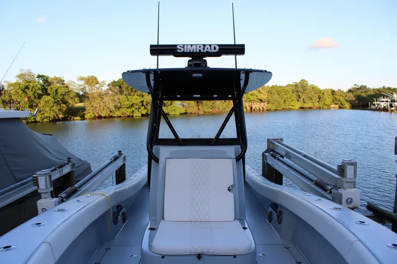 Yacht Photos Pics 2019 Conch 33 boat with Simrad equipment docked by a scenic river.