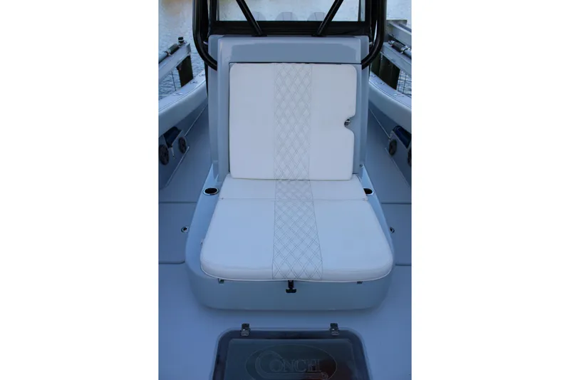  Yacht Photos Pics 2019 Conch 33 boat seat with white cushioned upholstery and diamond pattern stitching.
